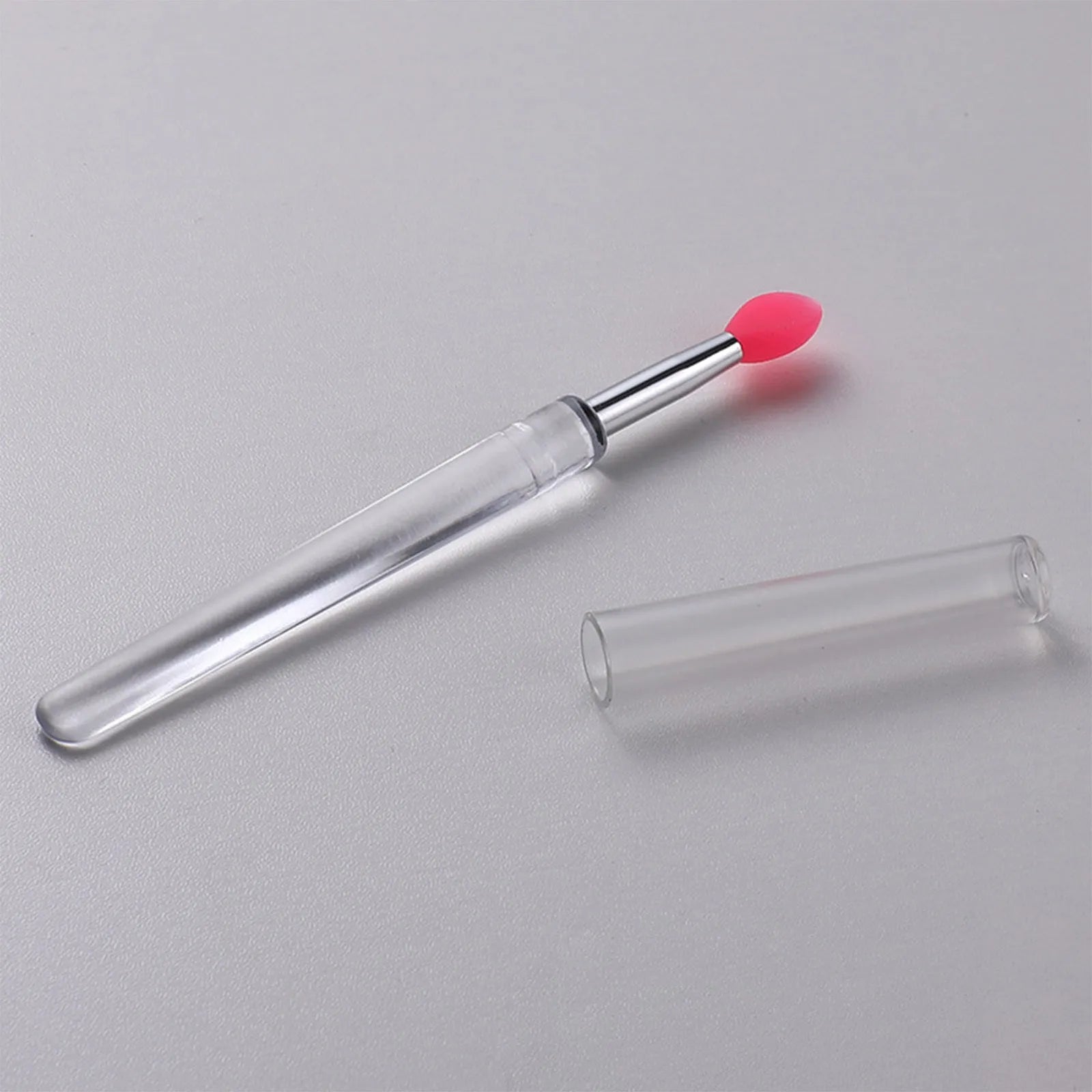 Silicone lip brush with protective cap for hygienic lip product application