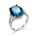 Blue black copper geometric ring with elliptical element on white background