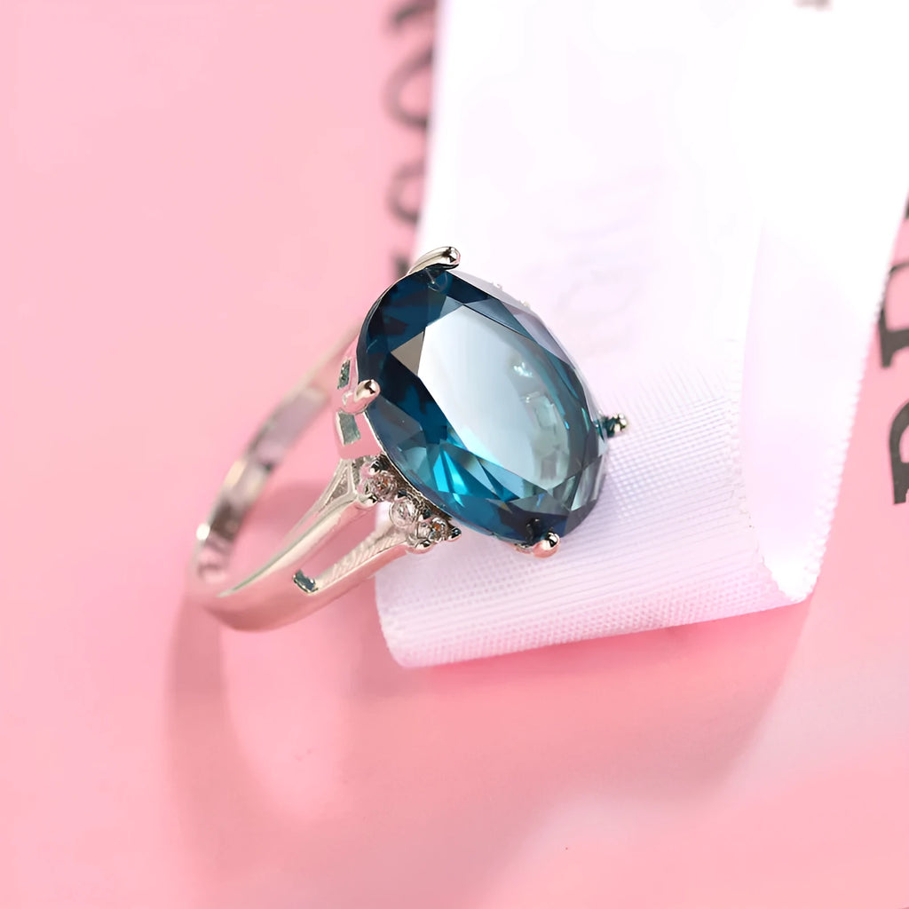 Blue black copper geometric ring with elliptical element on white background