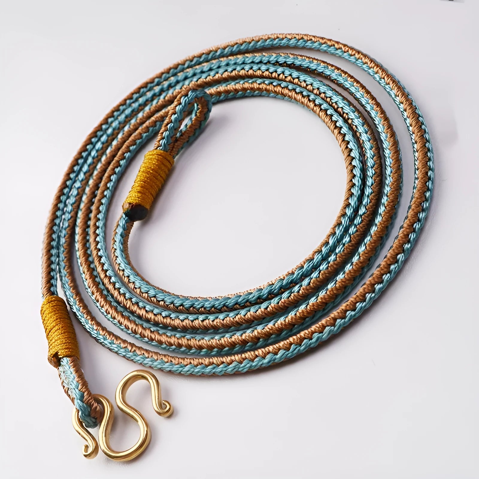 Gold peace buckle choker necklace with intricate mixed gemstone inlaid pendant on a model.