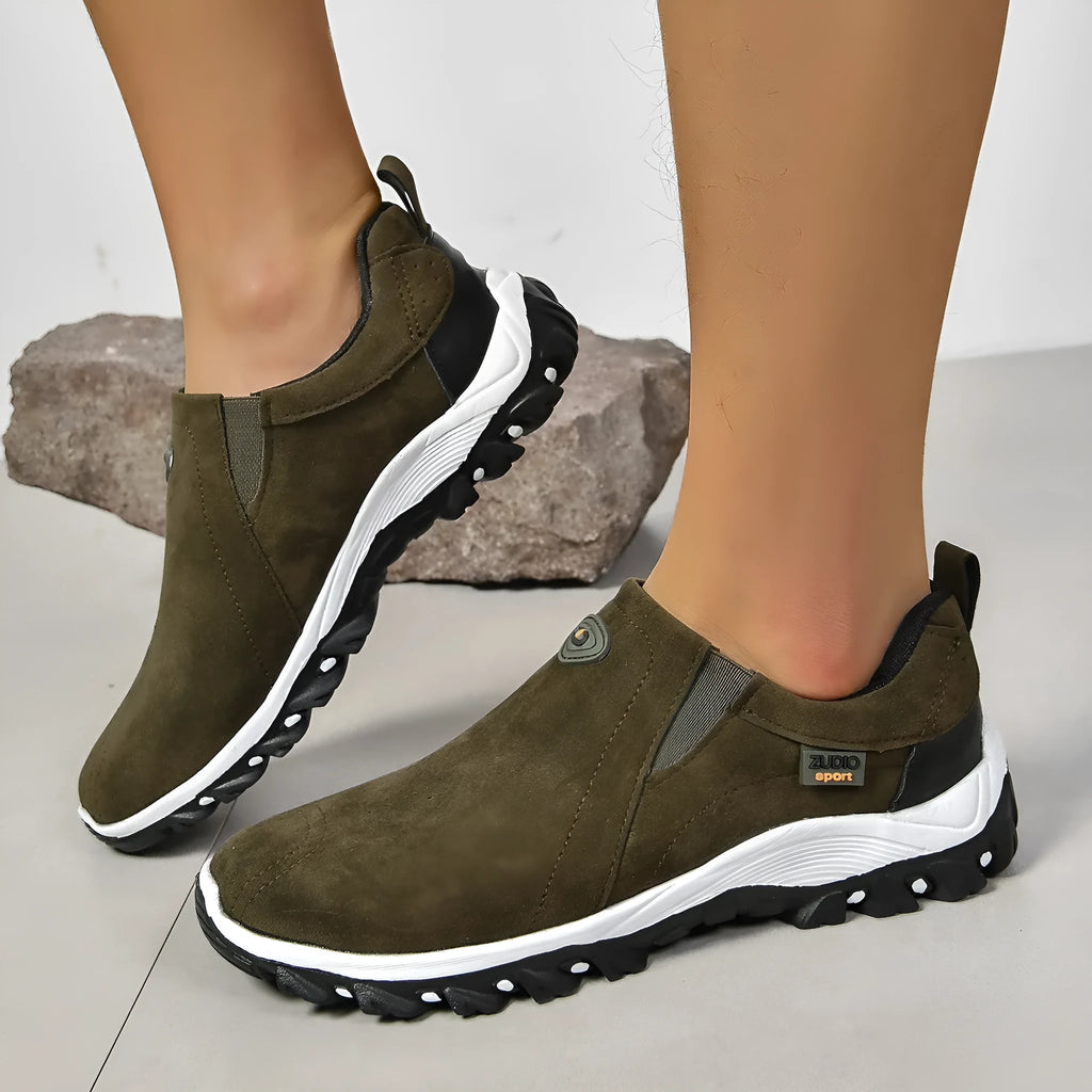 Men's grey slip-on shoe cover with round toe and rubber sole on a white background.