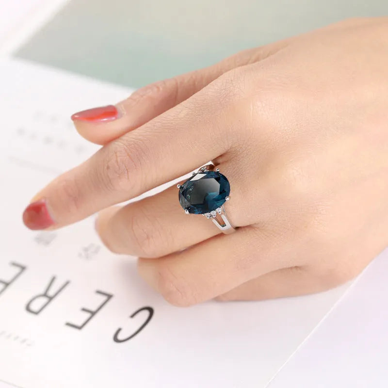 Blue black copper geometric ring with elliptical element on white background