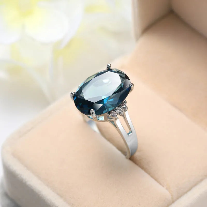 Blue black copper geometric ring with elliptical element on white background