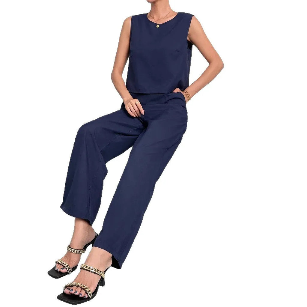 Red two-piece set with sleeveless round neck top and wide-leg trousers laid flat