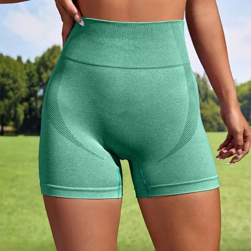 Women's high-waisted seamless sport leggings in a solid colour, shown on a model for yoga or fitness.