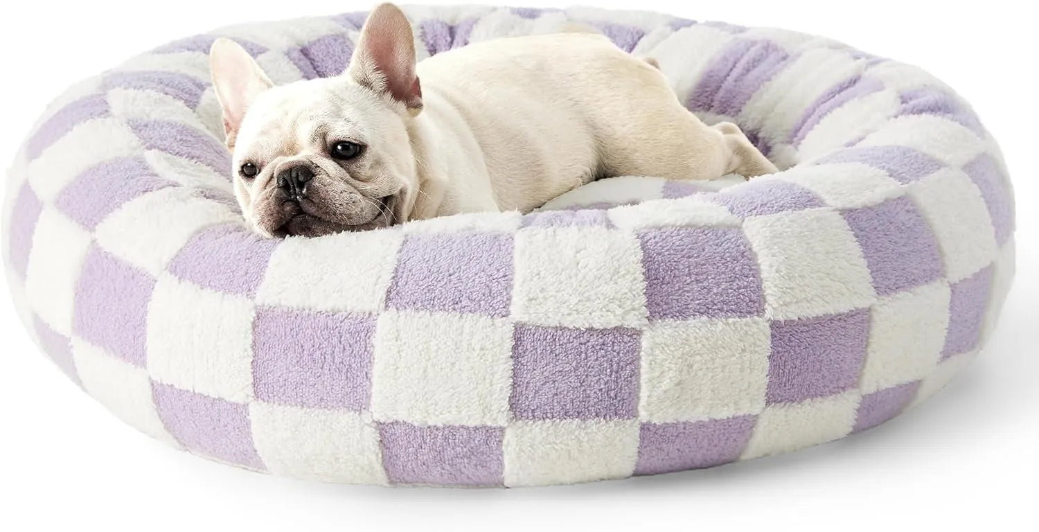 Round blue and white plaid dog bed with a removable cover on a plastic base.