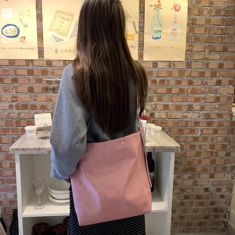 Corduroy one-shoulder commuter bag in pink colour showing textured fabric and structured design