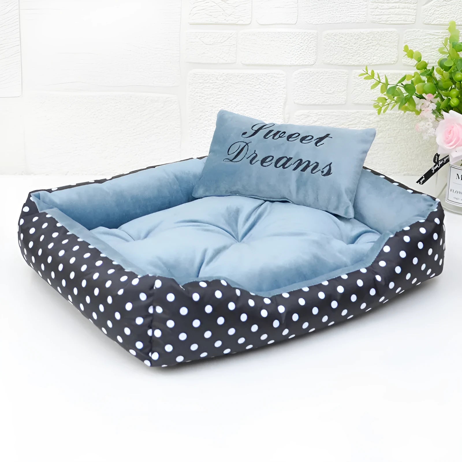 Polka dot print dog bed with a matching square pillow in grey, blue, pink, or red.