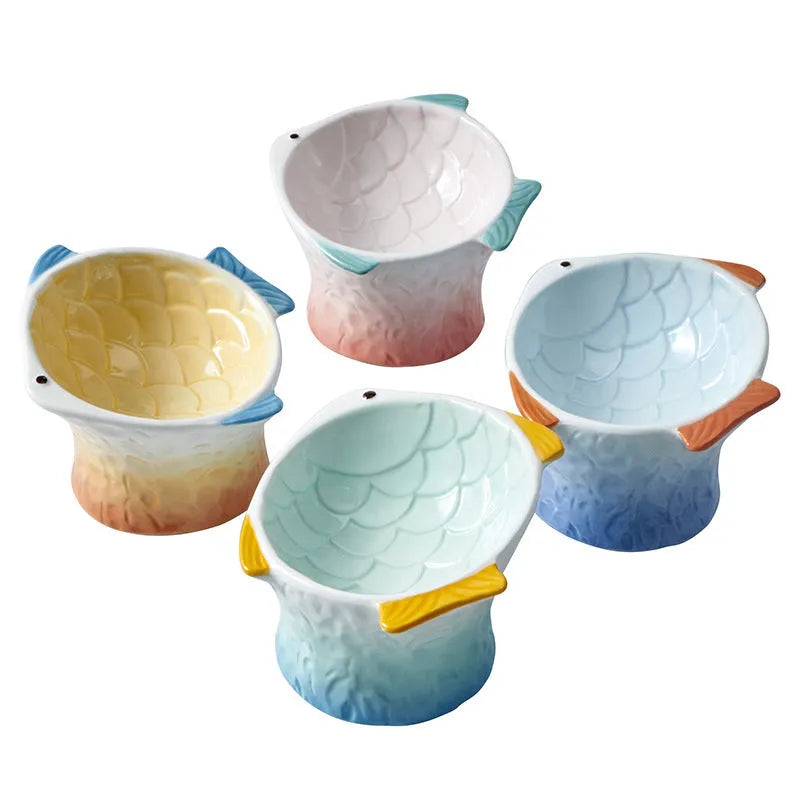 Set of four blue fish-shaped ceramic cat bowls with tilted design and elevated base