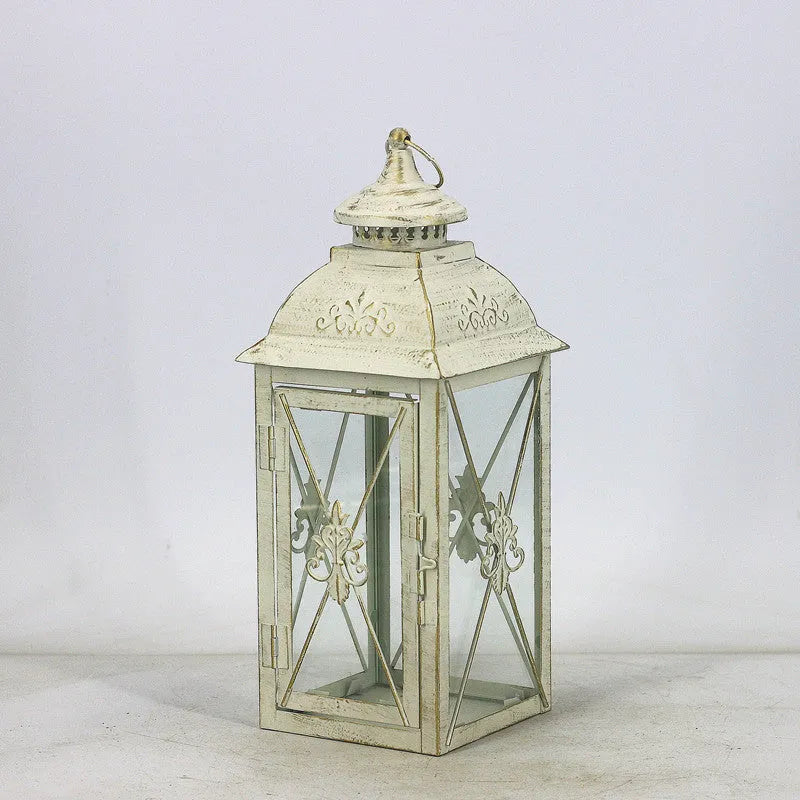 Black and white wrought iron floor-standing storm lantern with tempered glass panels for courtyard use