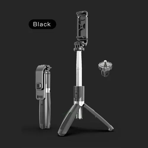 Black and white Bluetooth selfie stick with wireless remote, extended on a tripod base next to a smartphone.