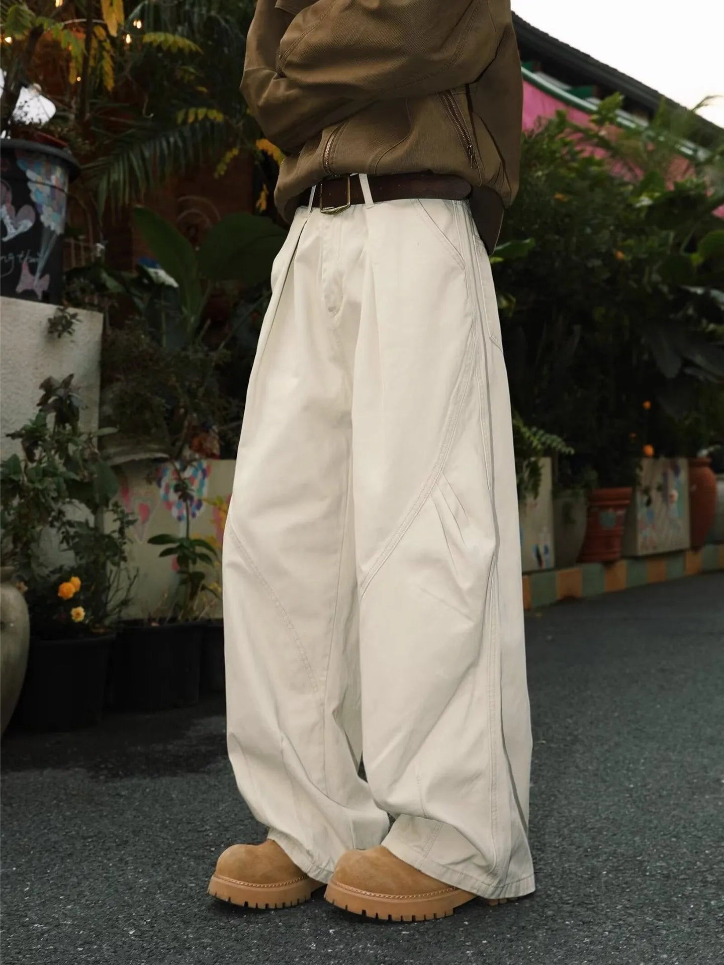 Men's pleated straight-leg trousers in apricot colour showing elasticated waistband detail.