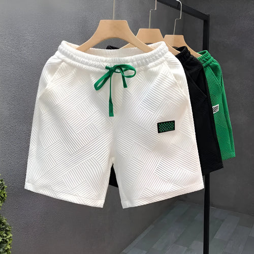 Casual solid colour sports shorts made from elastic polyester fabric.