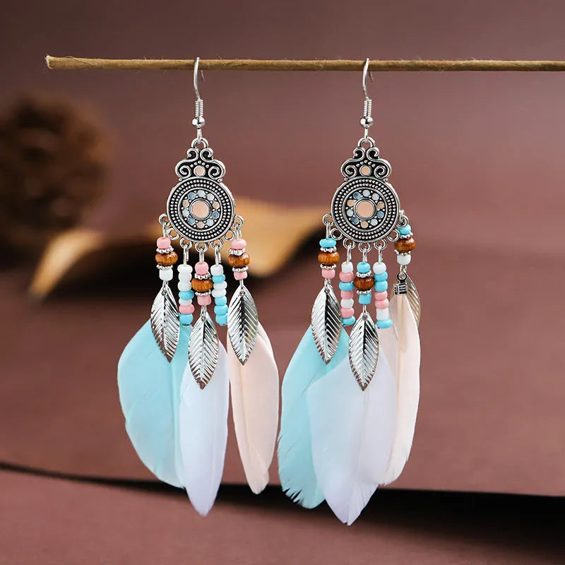 A pair of bohemian-style round drop earrings with a feather leaf pattern, shown in one of thirteen available colours.