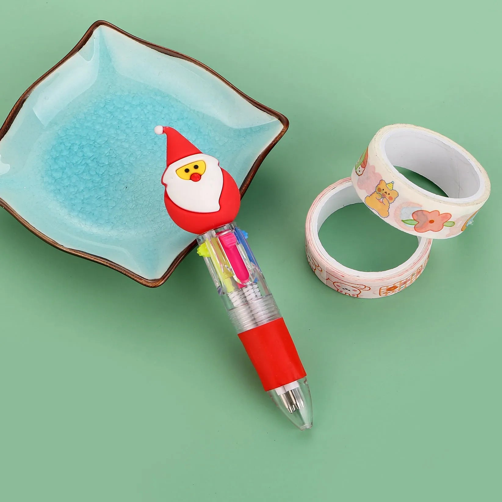 Compact 11cm Christmas four-colour press pen with festive designs including reindeer and snowmen.