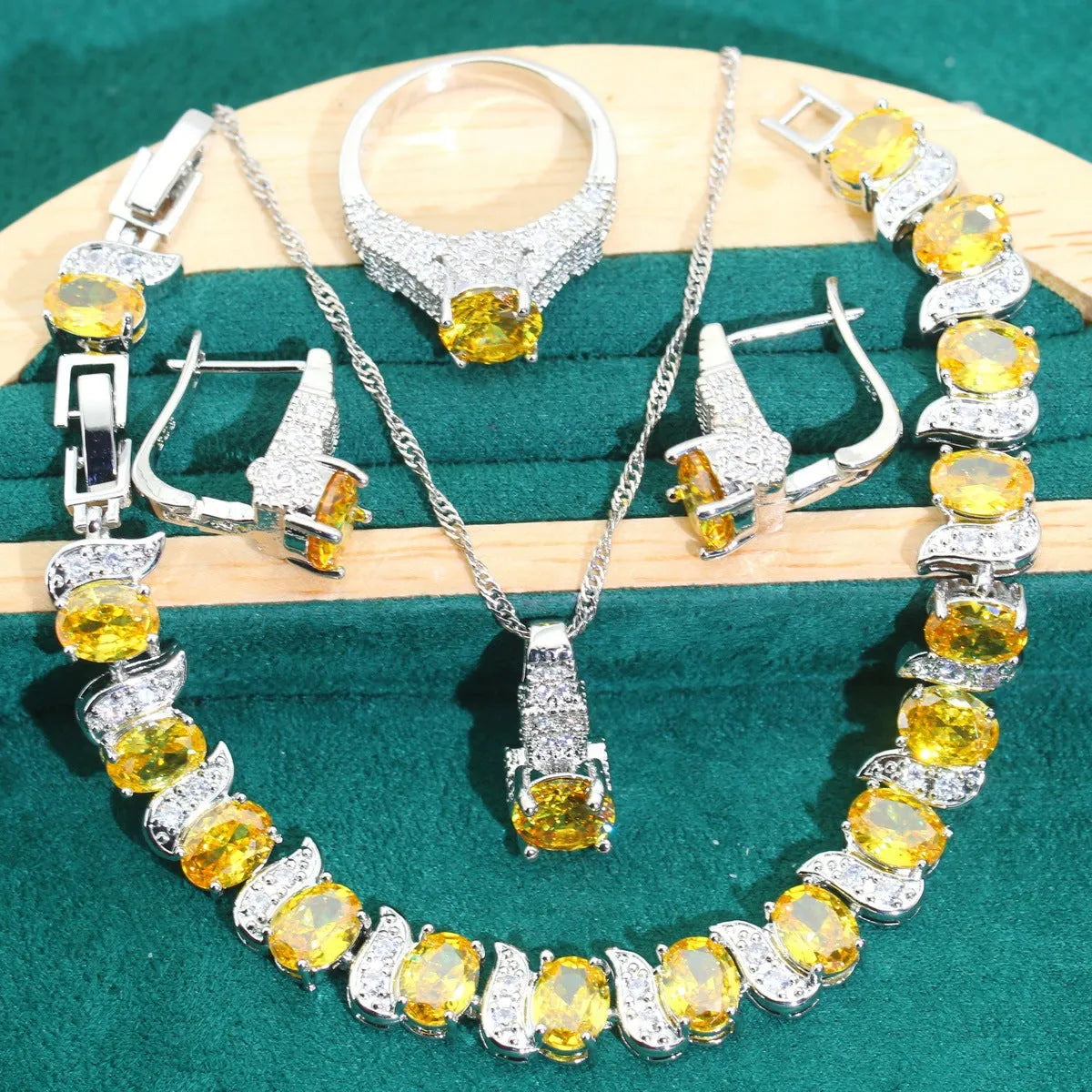 Four-piece bridal jewellery set showing necklace, earrings, ring, and bracelet with alloy pendant and water wave chain