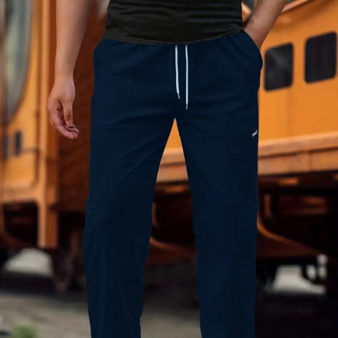 Men's lightweight polyester casual trousers in light grey colour shown flat