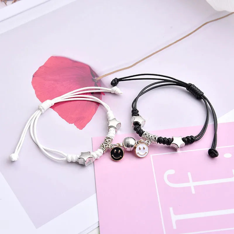 Pair of alloy suction bracelets with engraved symbol choices including crown, love lock, and clover.