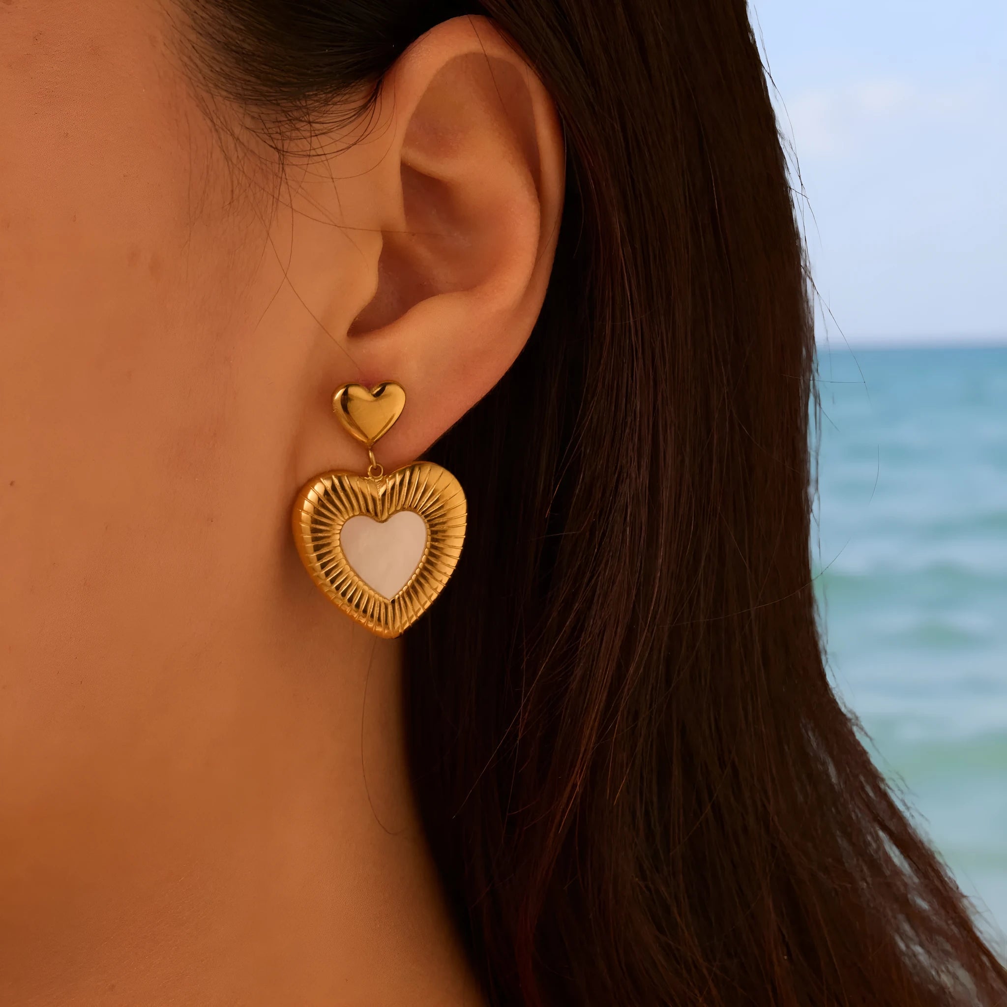 Heart-shaped stainless steel women's earrings with gold electroplated finish and love motifs