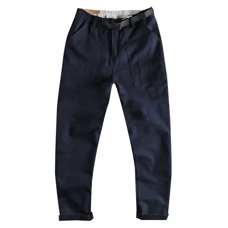 Men's khaki cotton work trousers with N I buckle belt showing three-dimensional cutting and mid waist design