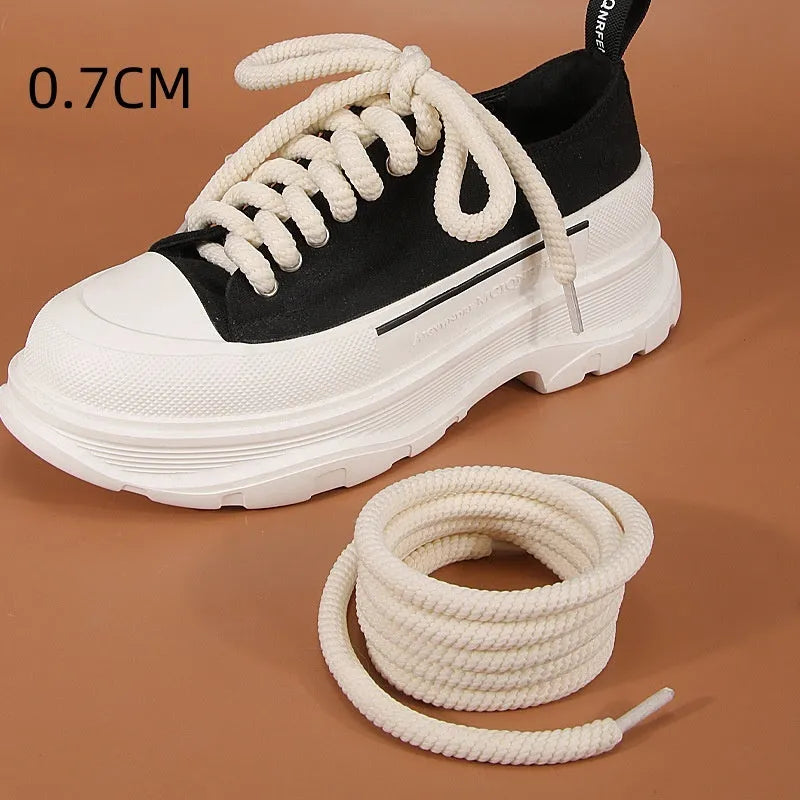 Pair of round woven shoelaces in white next to a ruler showing 10mm diameter and length scale.