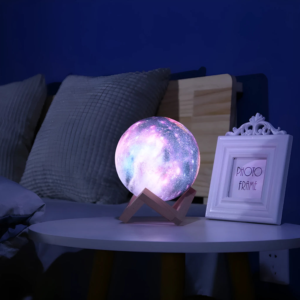 3D printed white lunar night light with colour-changing LED sphere on a stand, showing remote control.