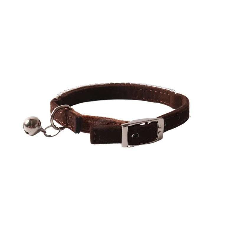 Soft pink flocking cat collar with silver elastic buckle, shown adjusted to fit.