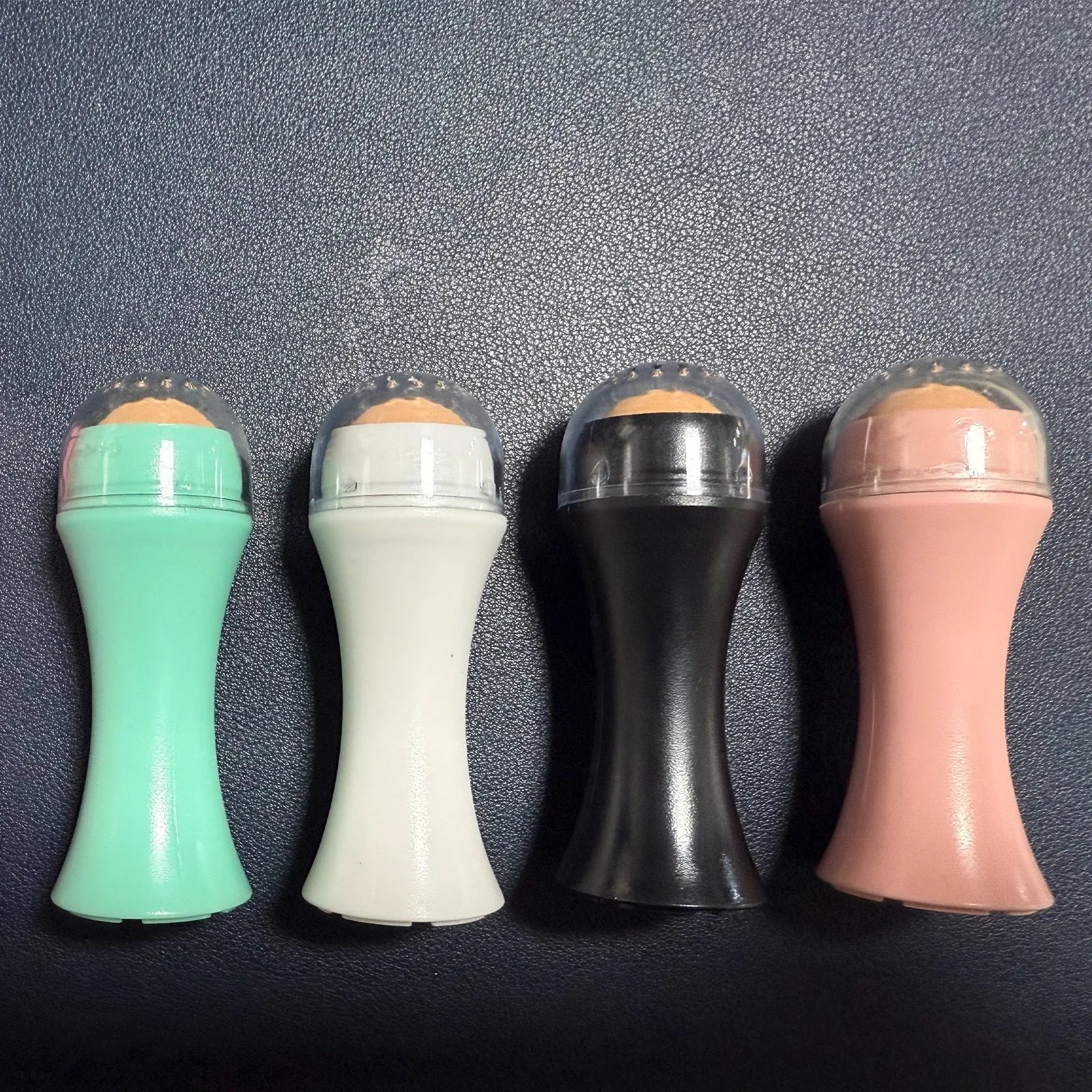 Mini volcanic stone facial roller for oil absorption in four colour options