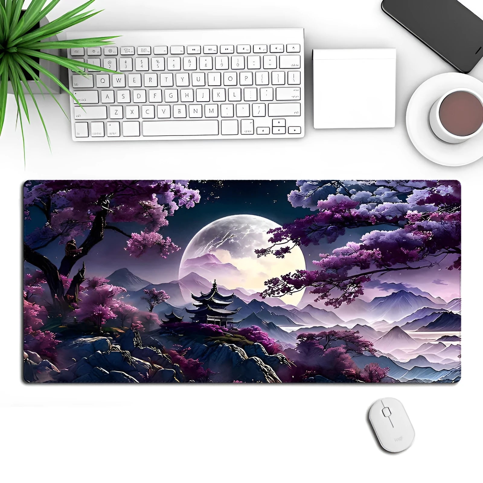 Large black gaming mouse pad with patterned design on a desk, showing keyboard and mouse placement.