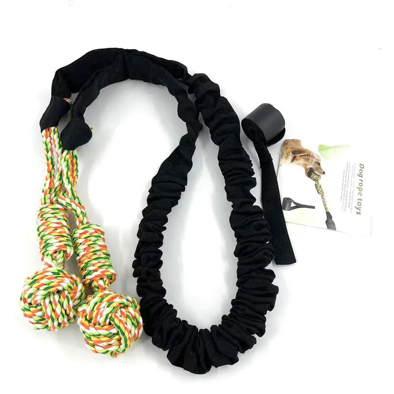A thick woven cotton dog tug of war rope toy in red, held at both ends.