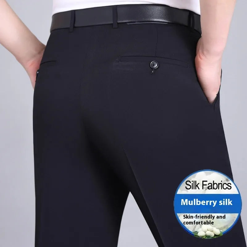 Man wearing black straight-leg high-waisted non-iron business trousers made from a Mulberry Silk blend fabric.