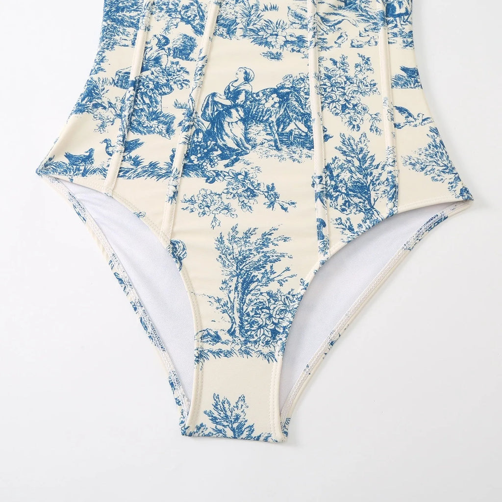Blue women's one-piece swimsuit with a matching gauze skirt on a size chart background