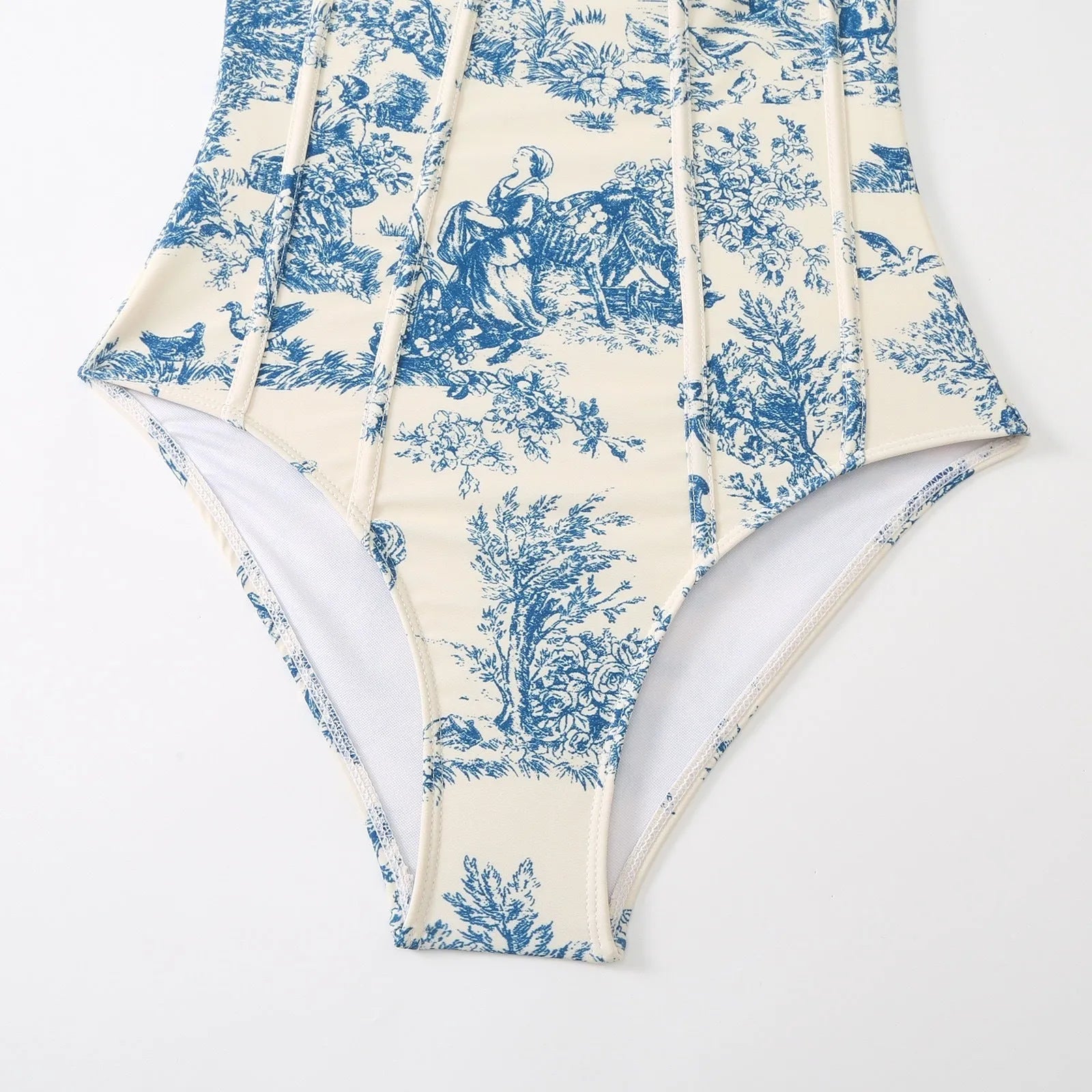 Blue women's one-piece swimsuit with a matching gauze skirt on a size chart background