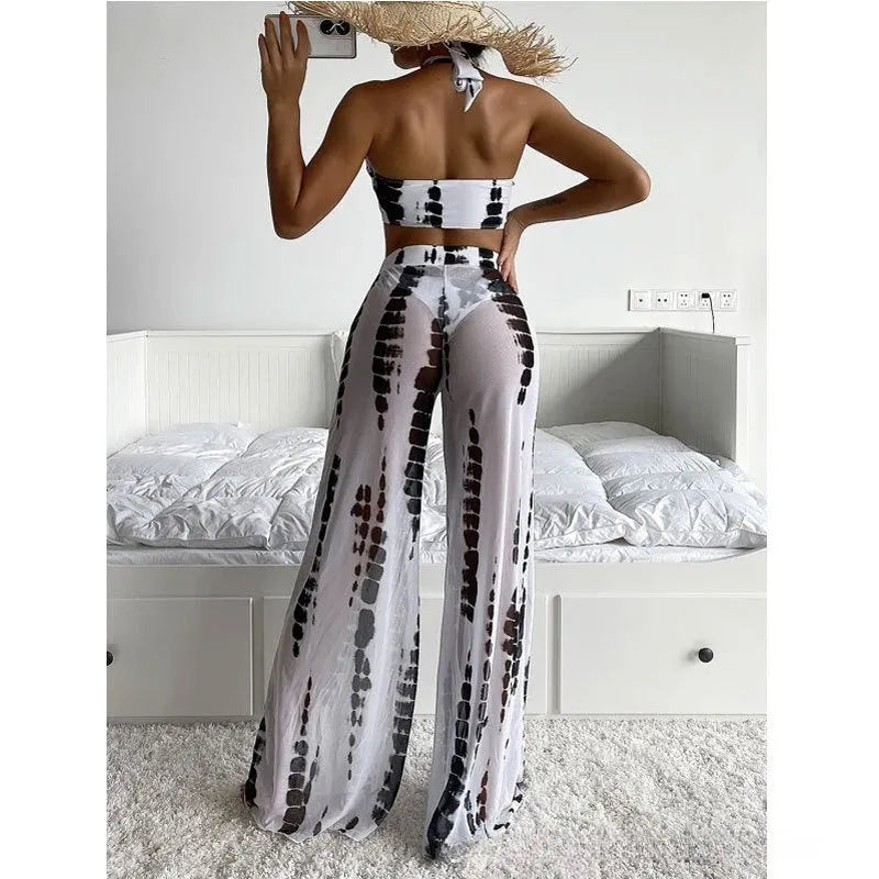 Women's black printed three-piece swimsuit set with bikini top, bottoms, and mesh trousers.