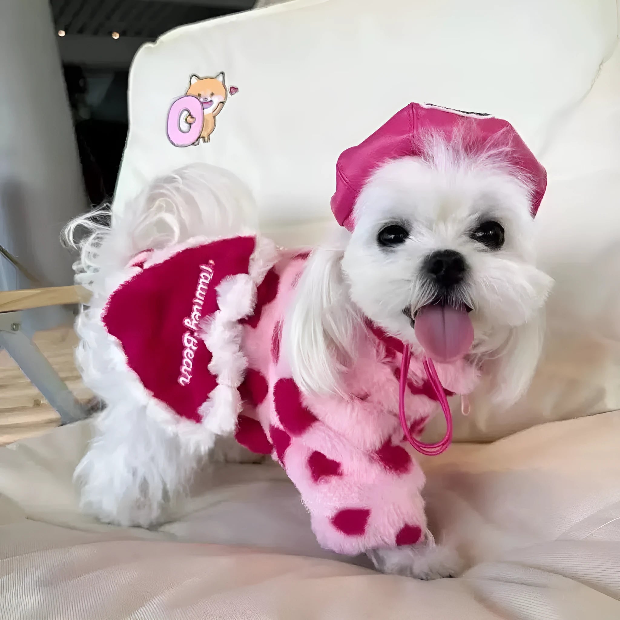 Pink polyester warm coat for small dog on white background showing British-style design