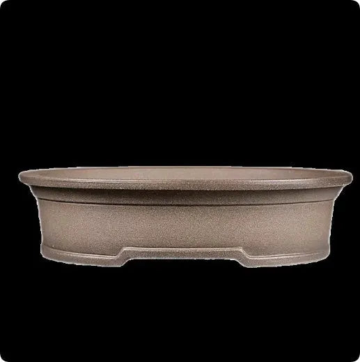 Handmade antique oval purple sand ceramic bonsai pot on a surface.