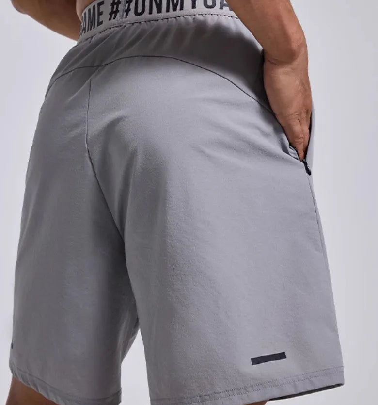 Men's loose fit cropped shorts in black with elastic fly opening and letter detailing