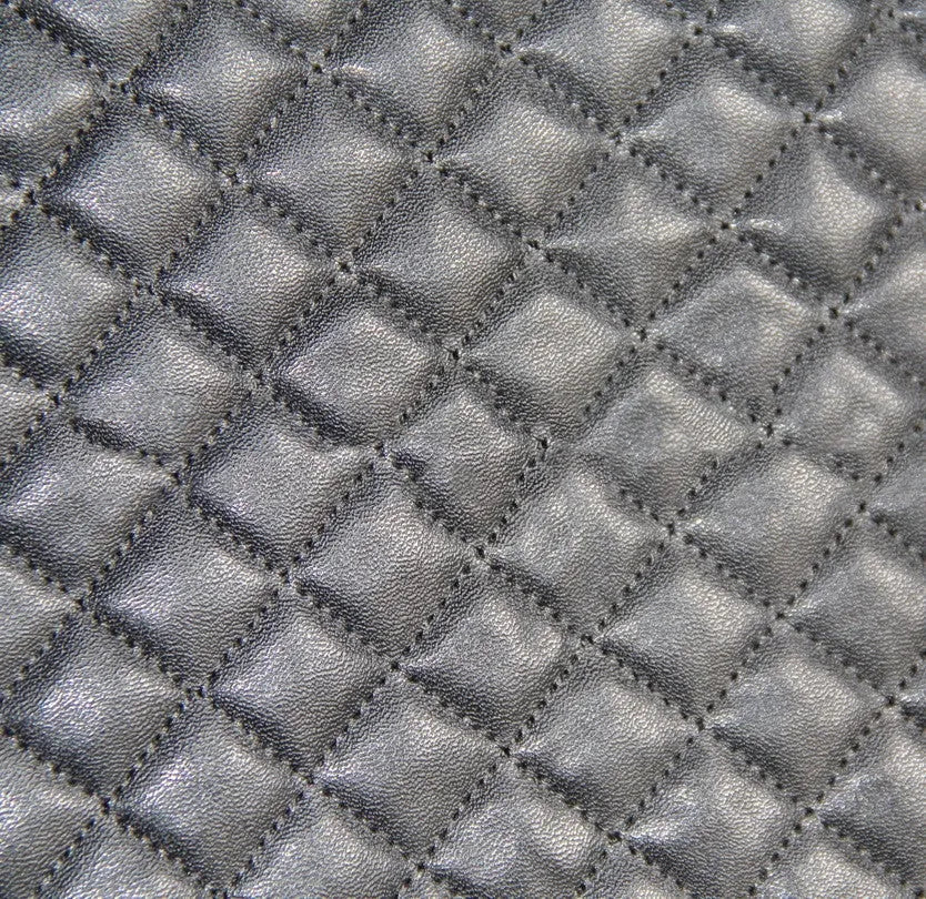 Black quilted automotive seat cover made from PU and polyester fabric, shown with plastic attachment hooks.