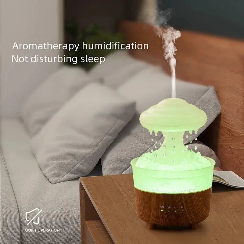 Wood grain green rain cloud shaped humidifier diffuser with coloured LED light on a table.
