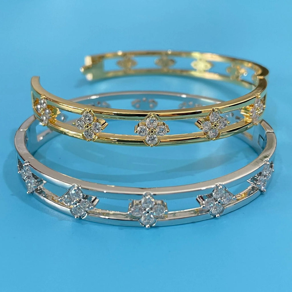 Gold or silver women's hollow bracelet with four-leaf clover design and zircon stones.