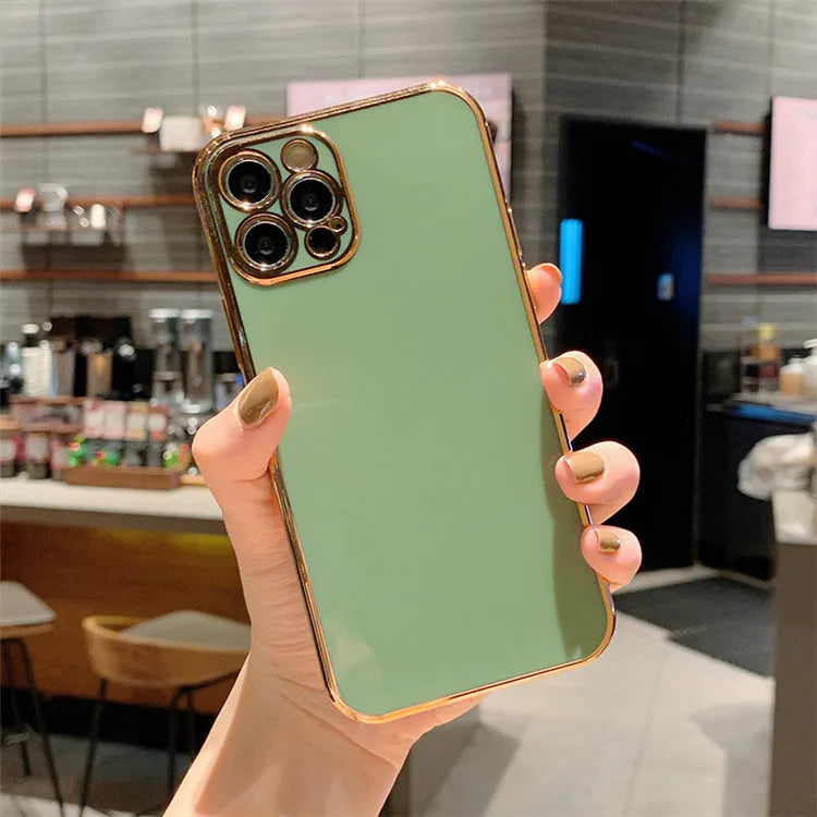 Gold plated iPhone case with silicone stripes in solid colour on an iPhone