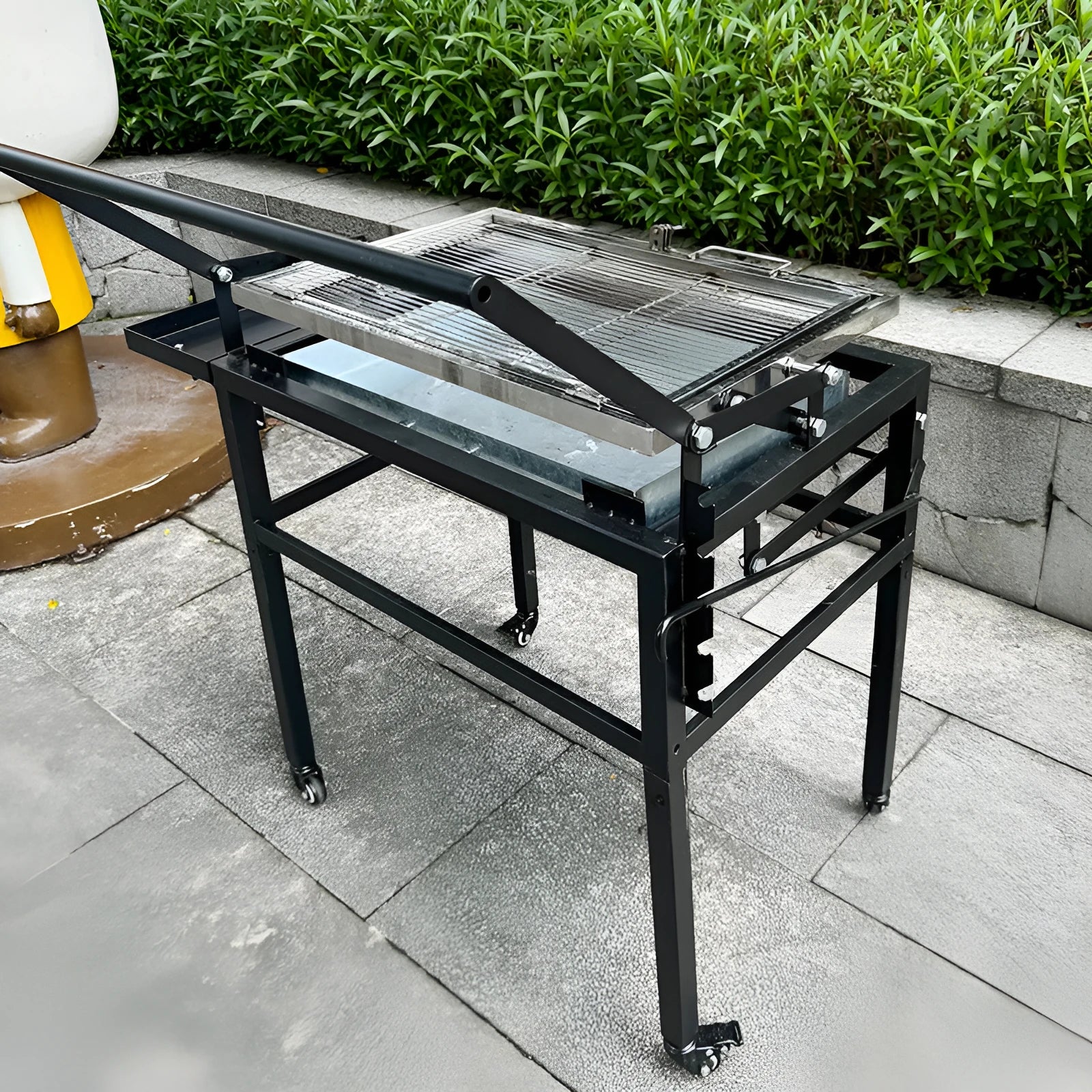 Large black portable charcoal barbecue grill with foldable detachable frame for outdoor cooking