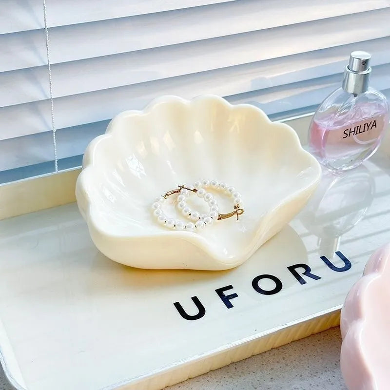 White or pink plastic shell-shaped soap dish for bathroom sink storage