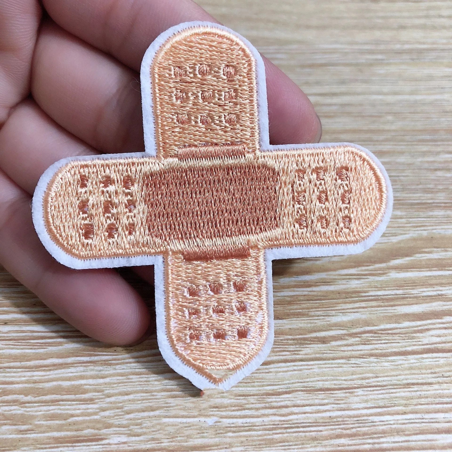 Pack of ten embroidered iron-on cloth patch badges for clothing and craft customisation.