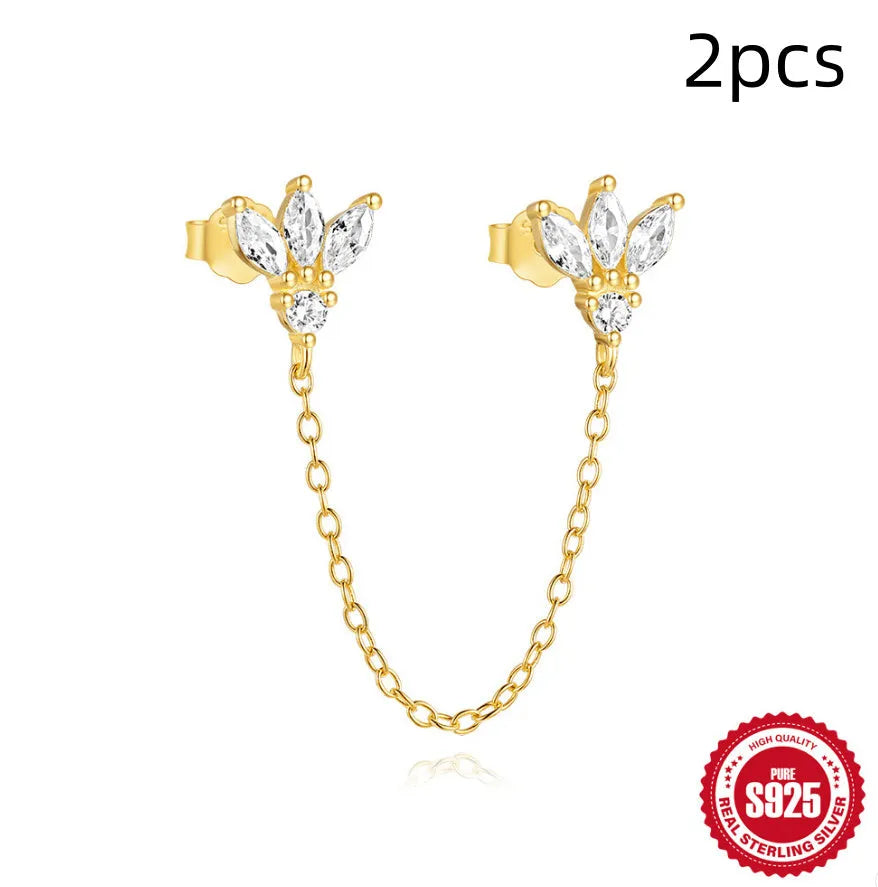 S925 sterling silver stud earrings with zircon inlay in golden geometric designs including clover and crown.