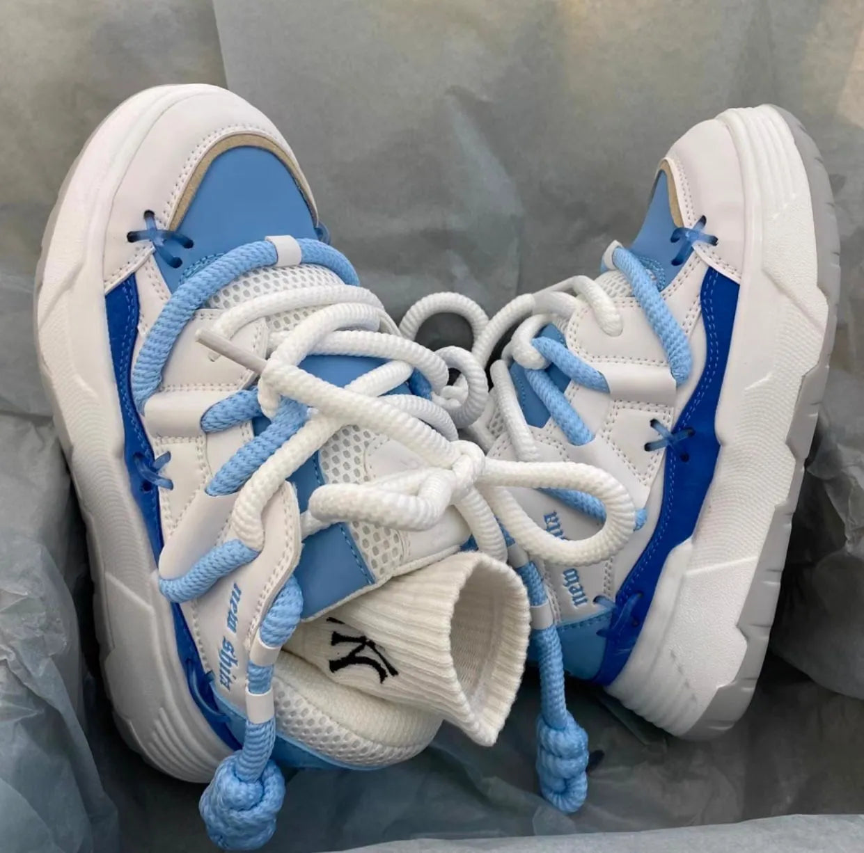 Women's grey retro chunky platform sneakers with thick rubber sole and lace-up front.