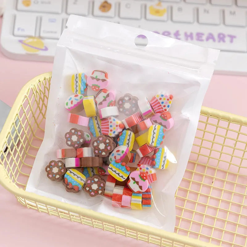 50 colourful cartoon mini erasers in shapes of fruits, animals, and cakes, displayed next to a pearlescent film bag.