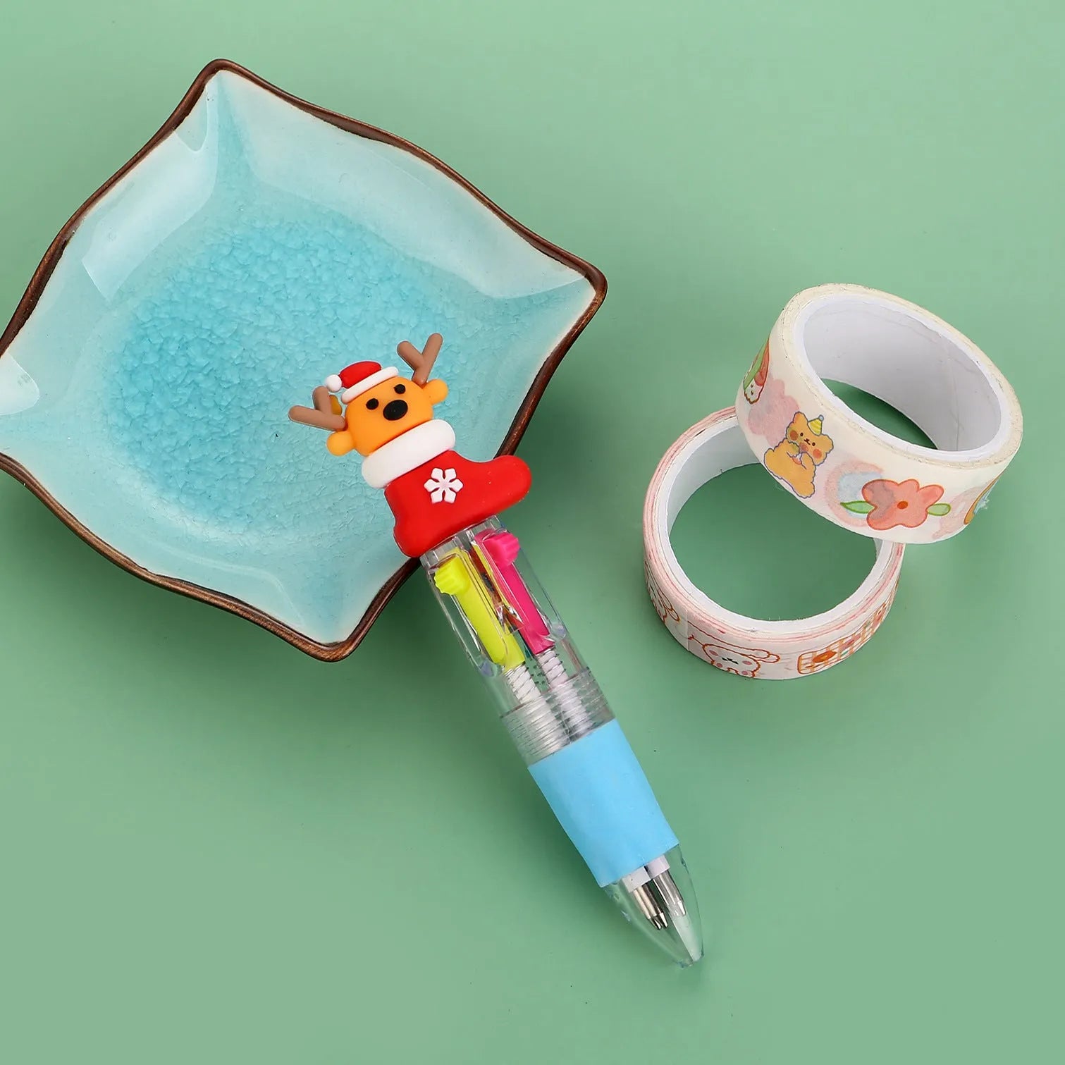Compact 11cm Christmas four-colour press pen with festive designs including reindeer and snowmen.