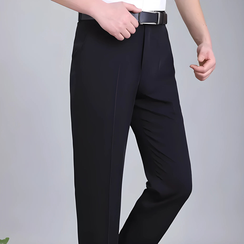 Man wearing black straight-leg high-waisted non-iron business trousers made from a Mulberry Silk blend fabric.