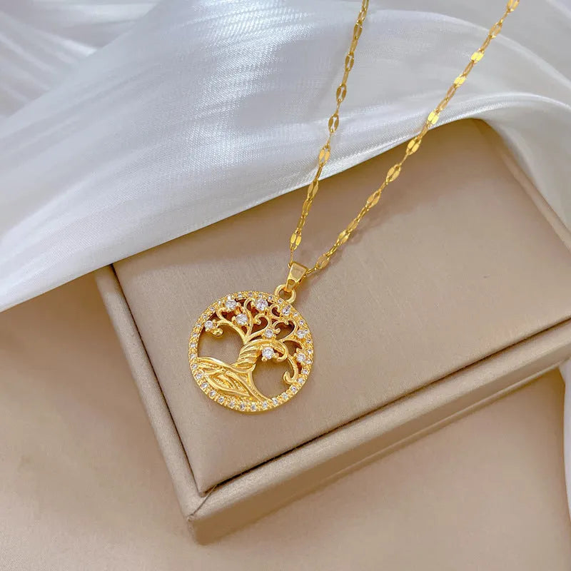 Gold plated Lucky Tree necklace with mother of pearl pendant and rhinestone zircon detail on a lip chain.
